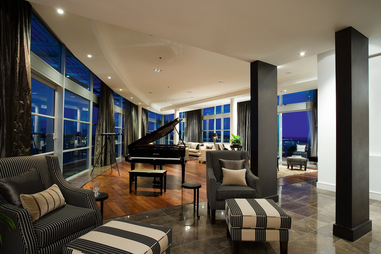 A view of this contemporary living area featuring apartment, ceiling, condominium, estate, home, interior design, living room, lobby, penthouse apartment, real estate, room, suite, black, brown