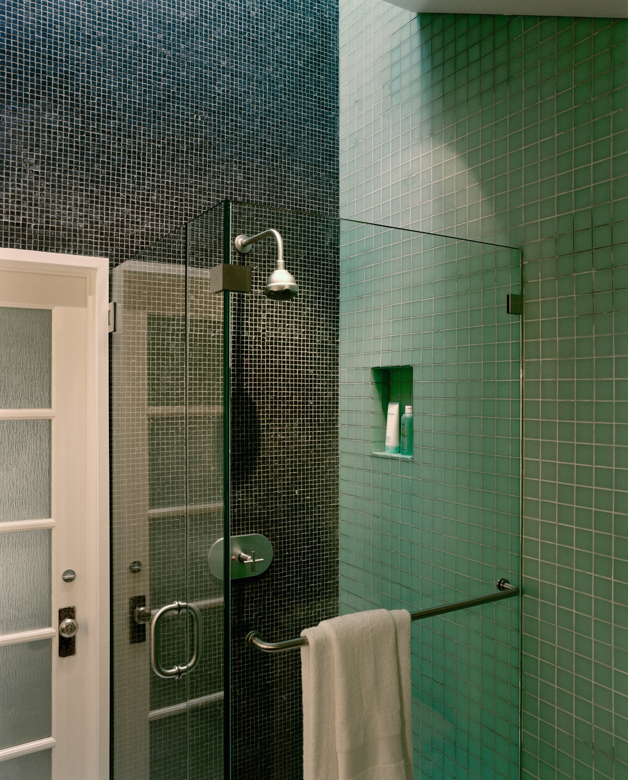 The frameless glass shower stall blends almost seamlessly bathroom, daylighting, floor, glass, plumbing fixture, public toilet, room, shower, tile, toilet, wall, green