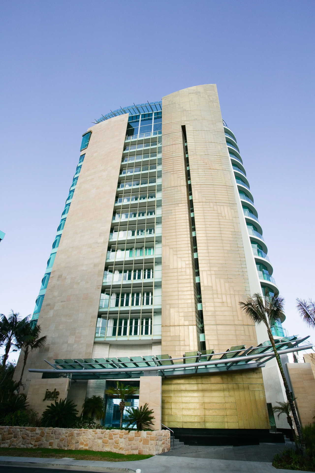 An exterior view of the Jade apartment tower apartment, architecture, building, commercial building, condominium, corporate headquarters, daytime, facade, headquarters, hotel, landmark, metropolis, metropolitan area, mixed use, real estate, residential area, sky, skyscraper, tower block, urban area, teal