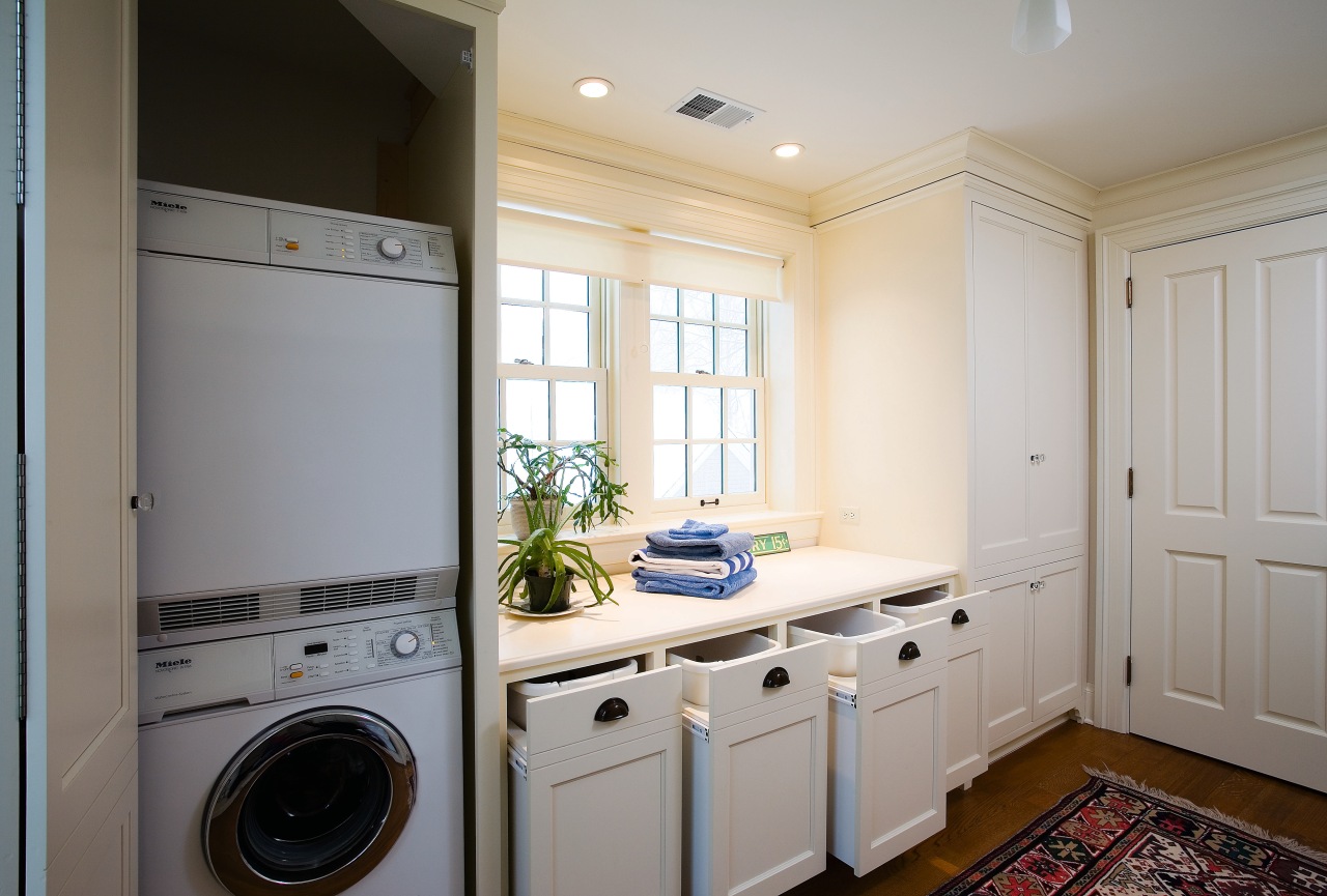 A view of this laundry featuring white timber cabinetry, clothes dryer, countertop, floor, home, home appliance, kitchen, laundry, laundry room, major appliance, room, washing machine, gray