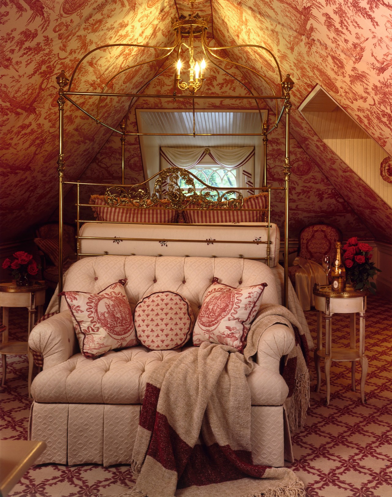 A view of this attic bedroom featuring an bed, bedroom, furniture, home, house, interior design, living room, room, textile, wall, brown, red, orange