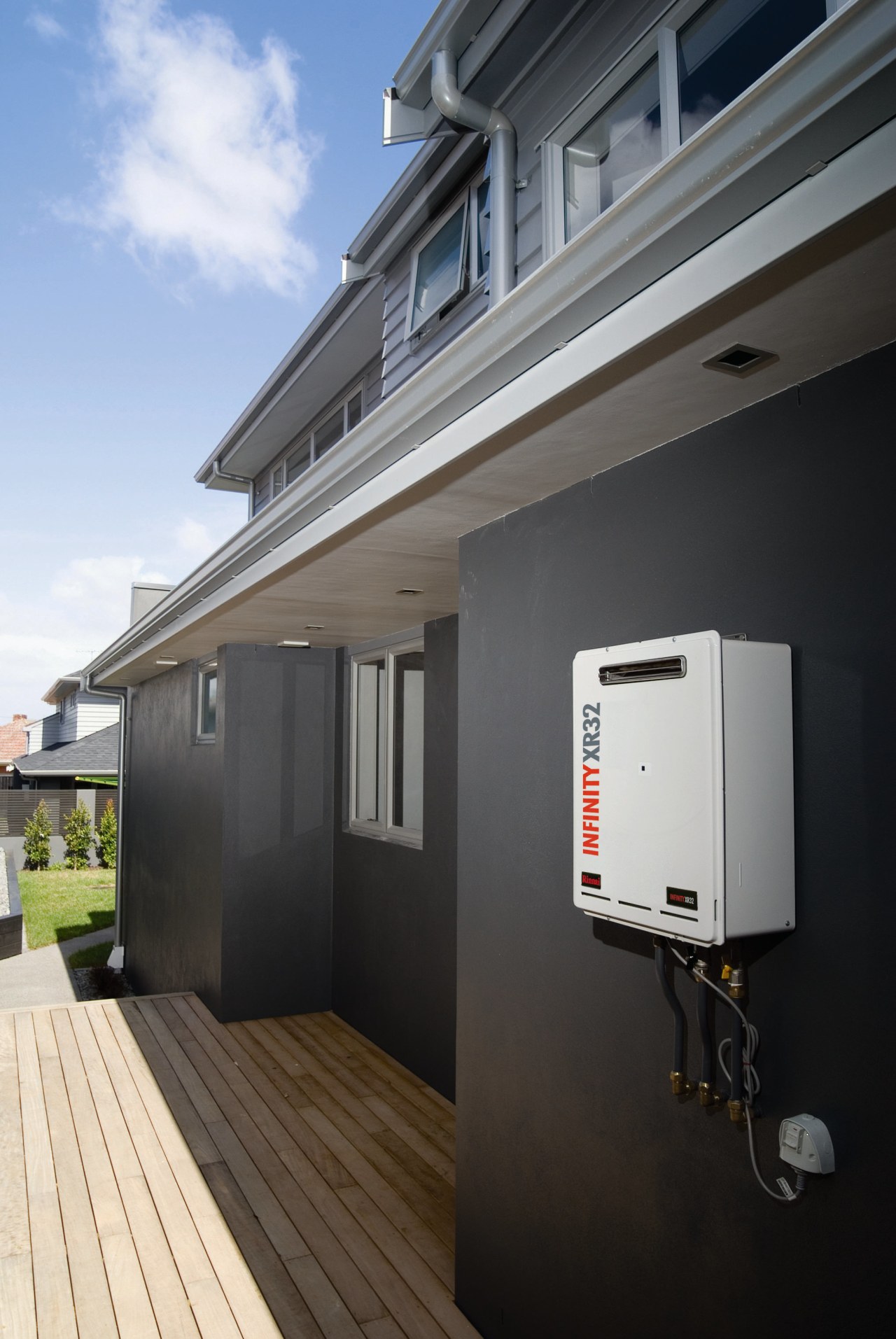 A view of a hot water system by architecture, building, facade, home, house, real estate, roof, siding, window, black