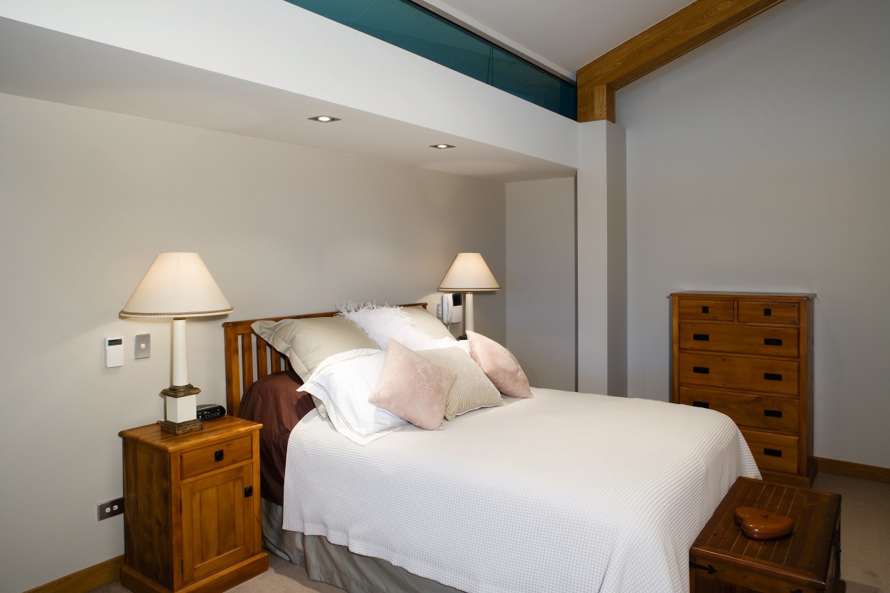 A view of this bedroom featuring resene white bed, bed frame, bedroom, ceiling, floor, furniture, home, interior design, property, real estate, room, suite, wall, wood, gray