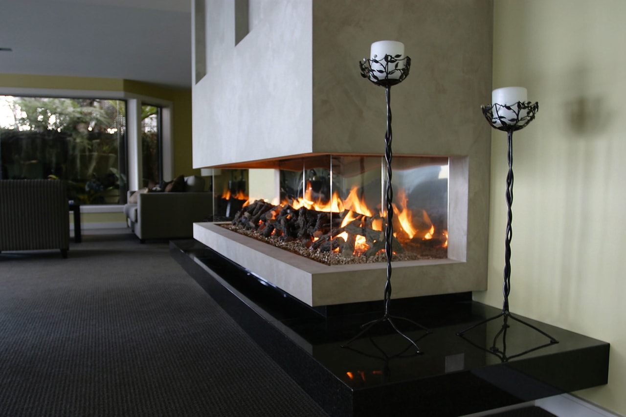 A view of a fireplace from Living Flame. fireplace, hearth, heat, wood burning stove, black, gray