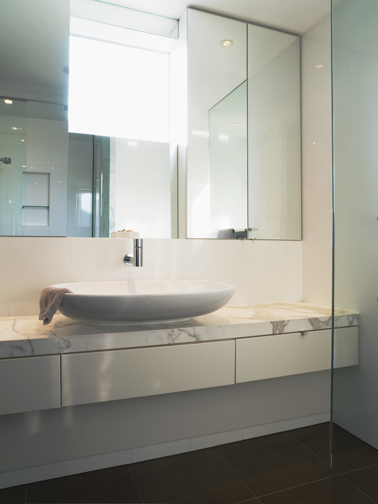 View of master bathroom featuring vanity top from bathroom, bathroom accessory, bathroom cabinet, bathroom sink, floor, glass, interior design, plumbing fixture, product design, room, sink, tap, gray, white