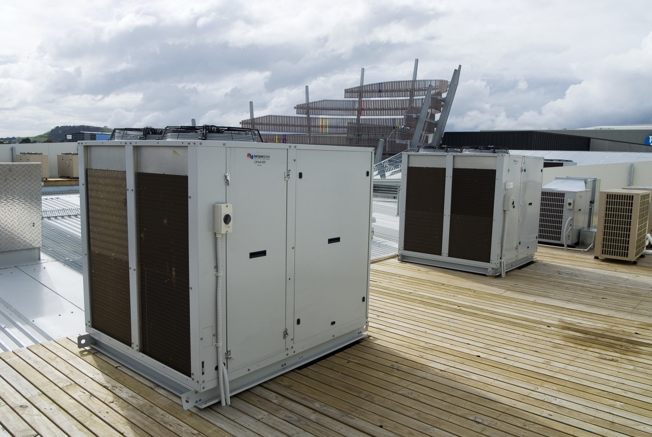 A view of an air conditioning unit from roof, gray, white