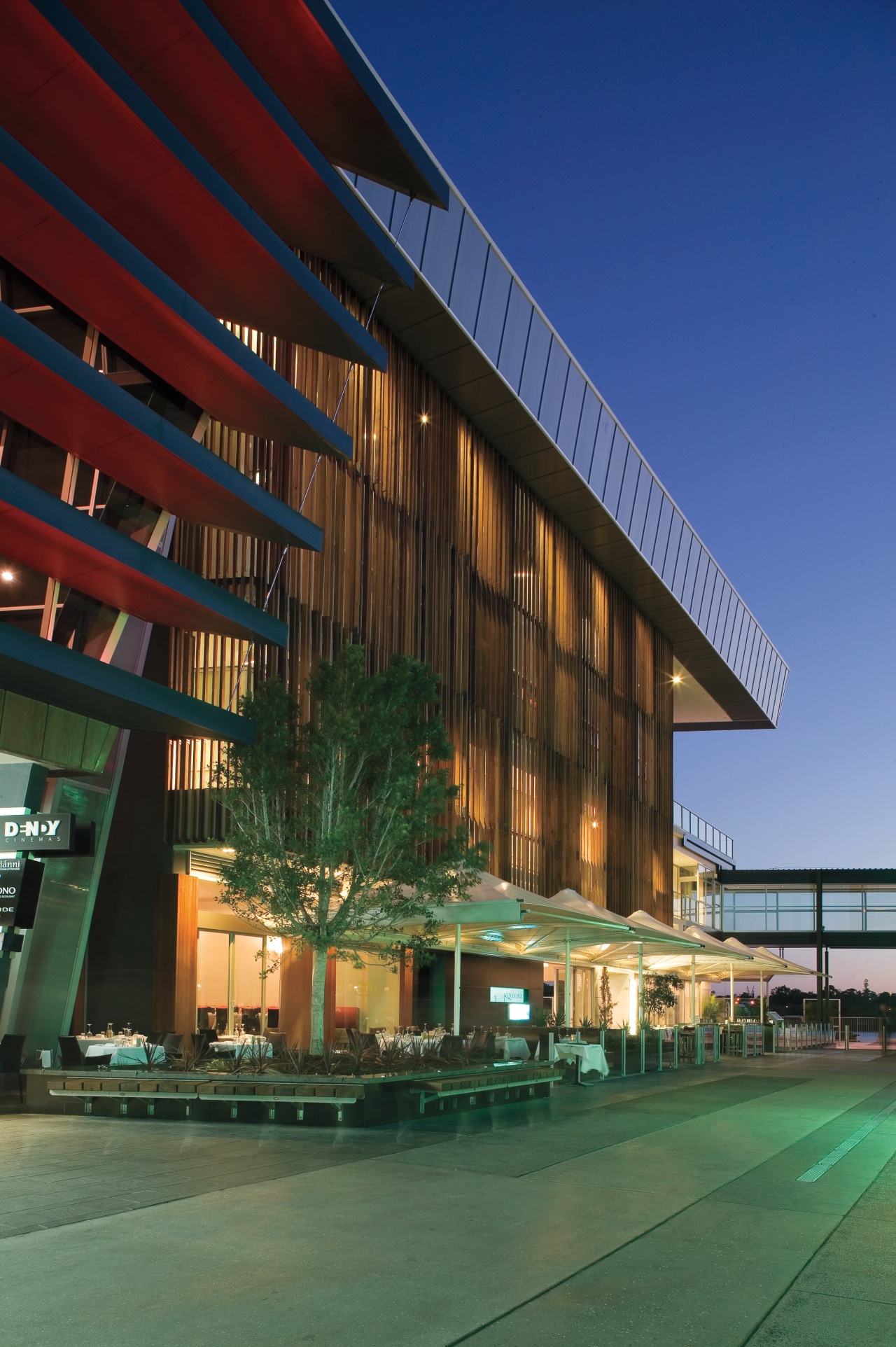 An exterior view of the Restaurants & shops architecture, building, commercial building, condominium, convention center, corporate headquarters, facade, headquarters, hotel, metropolitan area, mixed use, real estate, reflection, residential area, sky, structure, blue, green