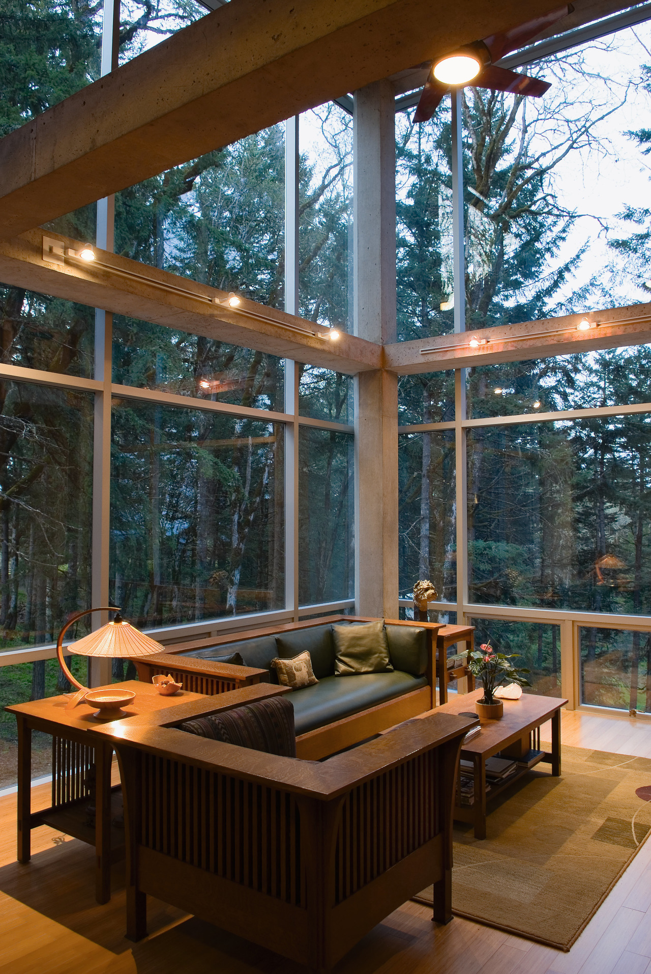 An interior view of the living area feautirng architecture, daylighting, deck, home, house, interior design, living room, outdoor structure, patio, table, window, wood, brown, black