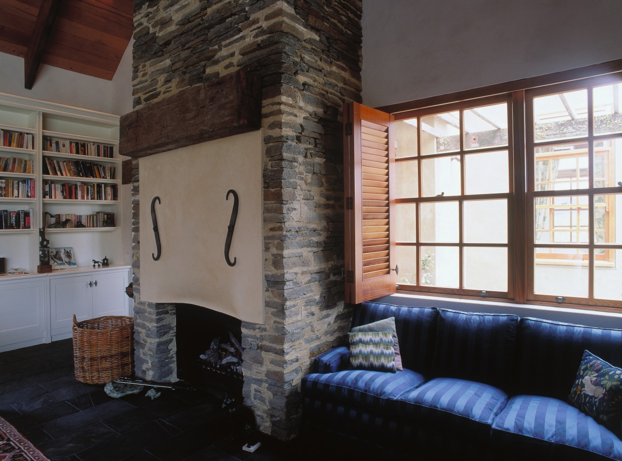 A view of the interior living areas featuring fireplace, hearth, home, interior design, living room, loft, property, real estate, room, wall, window, black