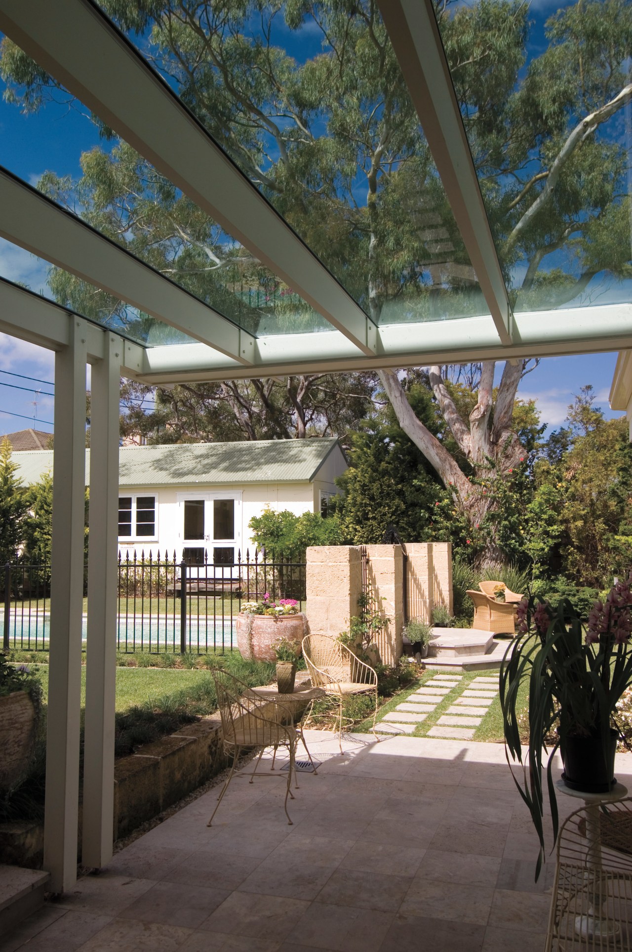 An exterior view of this renovated heritage home architecture, backyard, courtyard, estate, home, house, outdoor structure, patio, plant, porch, real estate, residential area, roof, structure, tree, walkway, black