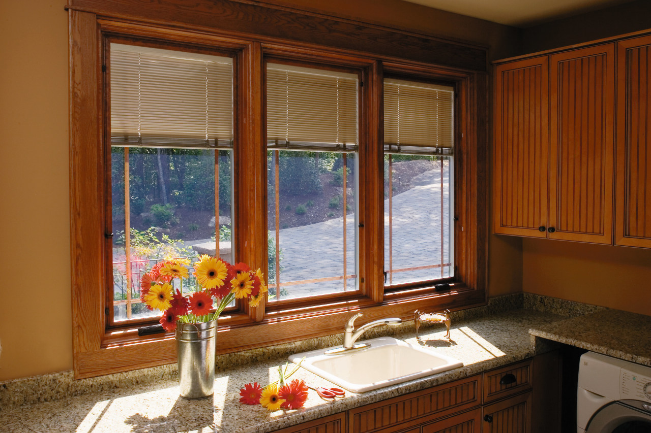 A view of this house featuring Pella timbers cabinetry, countertop, curtain, home, interior design, kitchen, real estate, room, window, window blind, window covering, window treatment, wood, brown