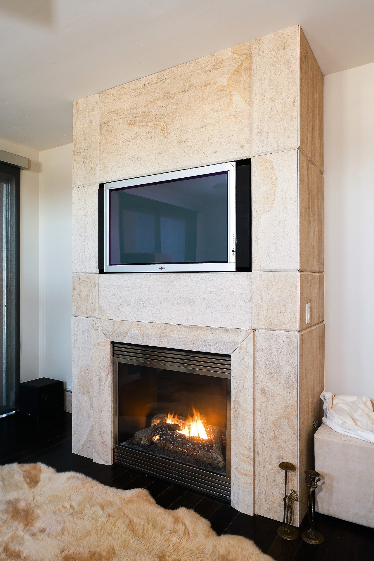 Large slabs of French limestone feature on the fireplace, floor, flooring, hearth, home, interior design, living room, wall, wood burning stove, gray