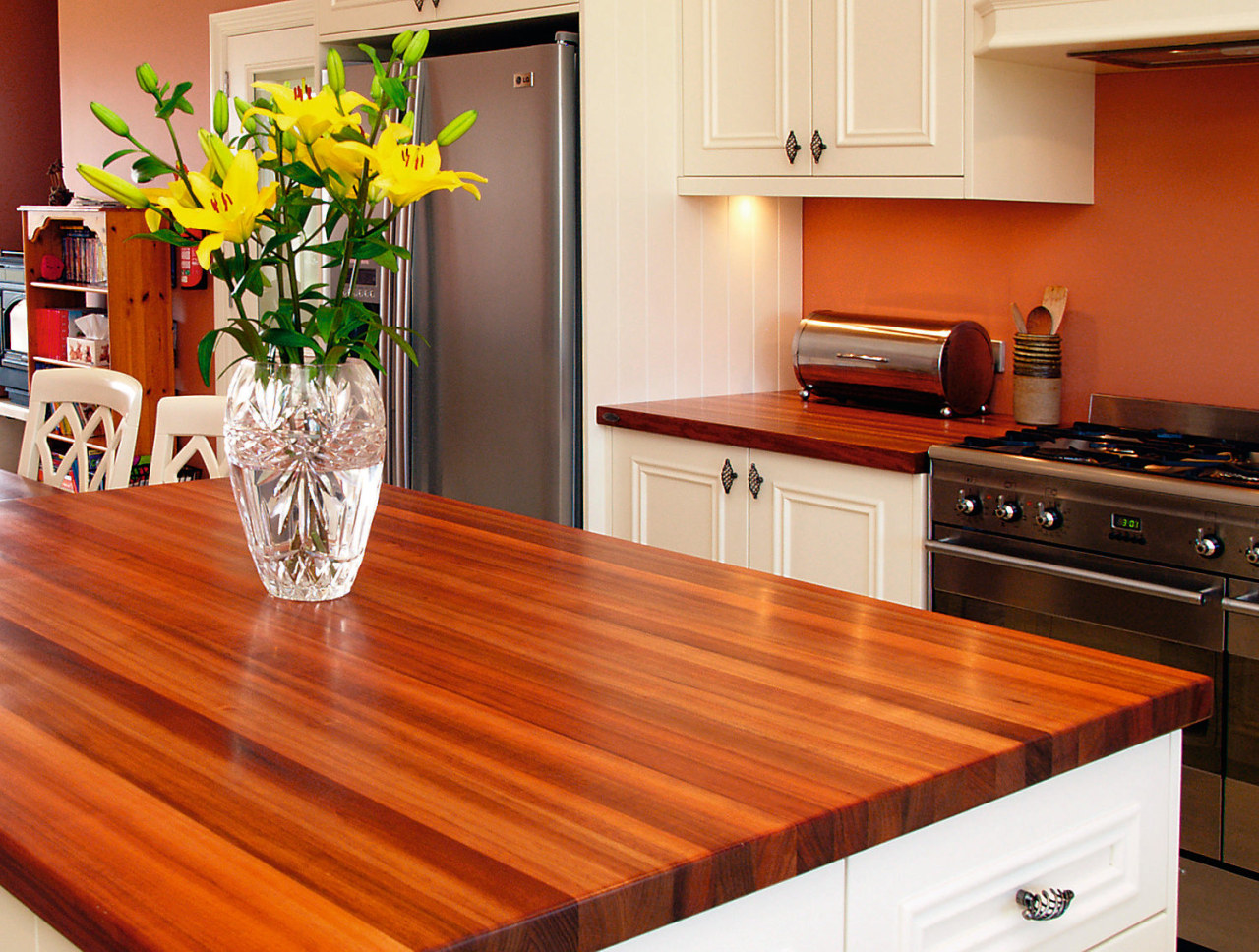 A view of this kitchen featuring blackwood timber cabinetry, countertop, floor, flooring, hardwood, interior design, kitchen, laminate flooring, table, wood, wood flooring, wood stain, red