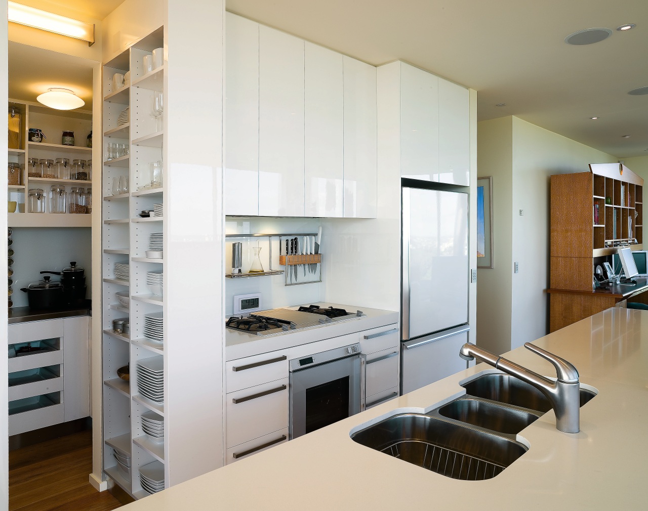The relatively compact kitchen features a number of cabinetry, countertop, home appliance, interior design, kitchen, gray, white