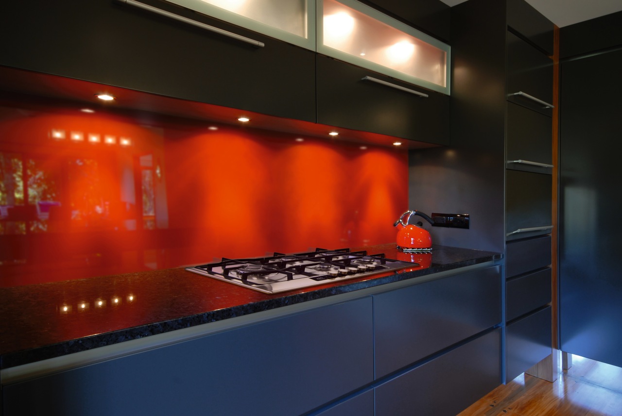 A view of this kitchen featuring AEG 5 countertop, interior design, kitchen, lighting, room, under cabinet lighting, black, red