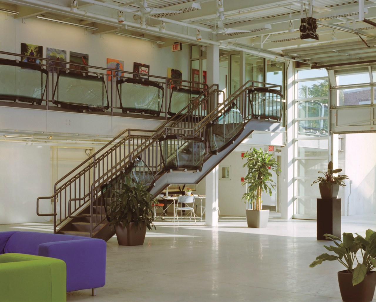 A large roller door on the south facade handrail, interior design, lobby, stairs, structure, gray, brown