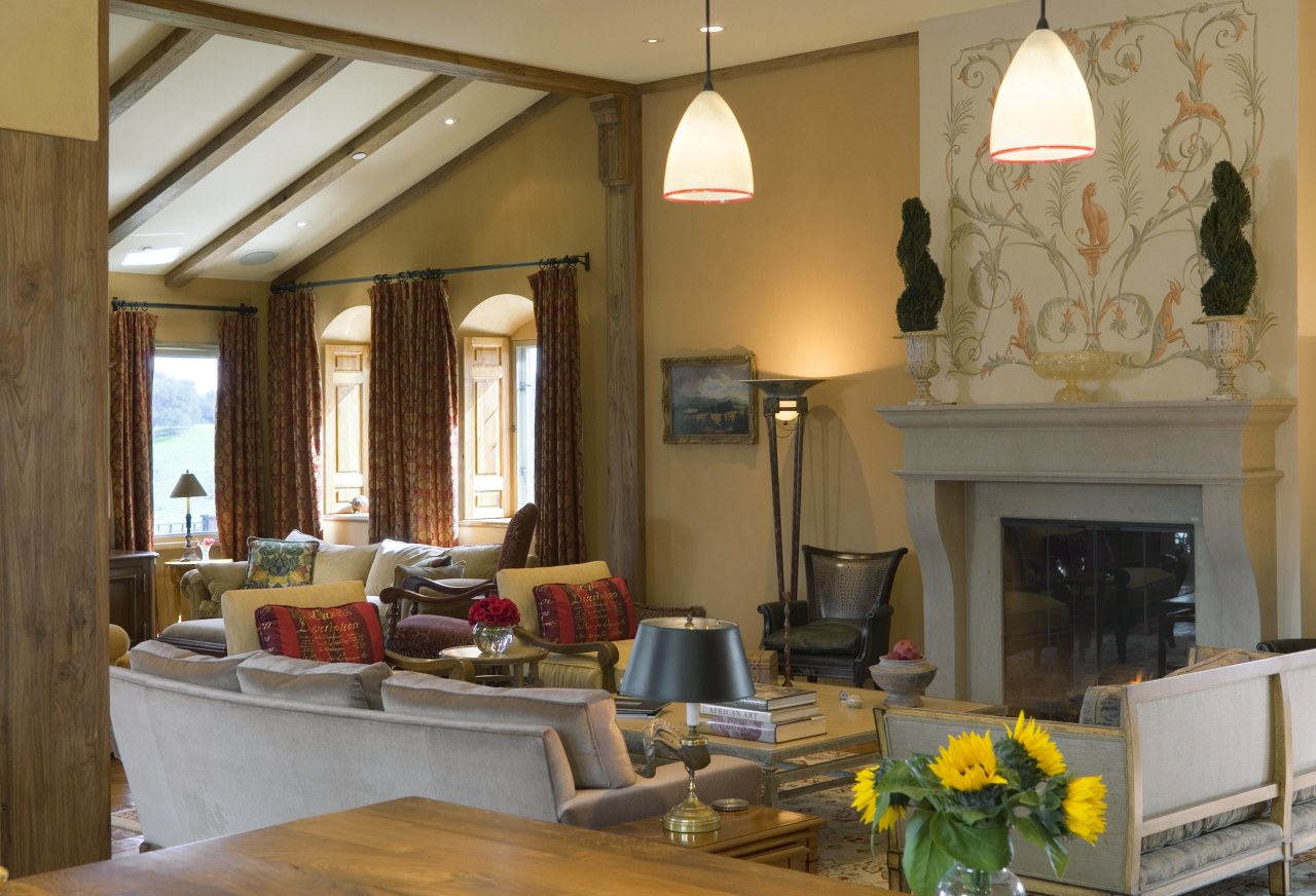 A view of the interior living area featuring ceiling, home, interior design, living room, lobby, real estate, room, window, brown