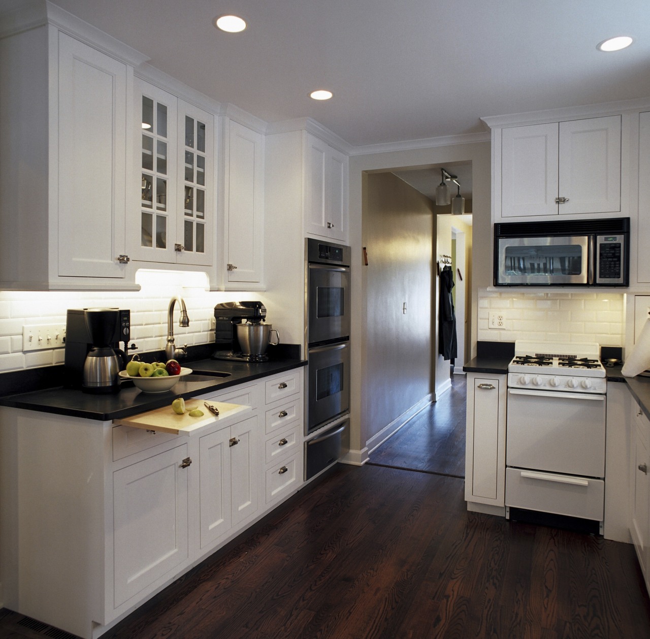 Three distinct food preparation areas allow the family cabinetry, countertop, cuisine classique, floor, flooring, hardwood, interior design, kitchen, room, wood flooring, gray