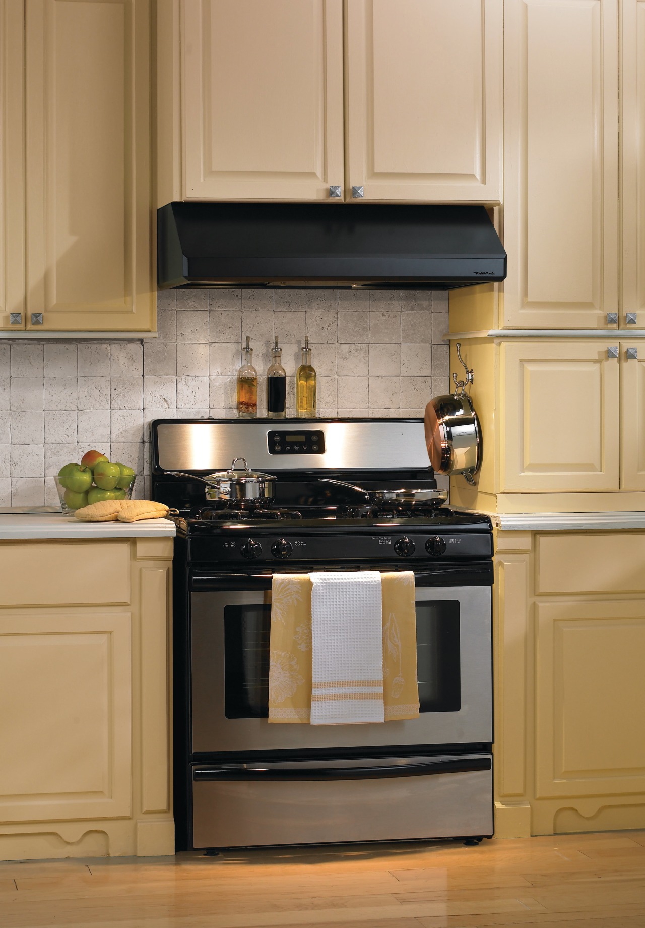 A view of a ventialtion system from Vent-A-Hood. cabinetry, countertop, cuisine classique, furniture, gas stove, home appliance, kitchen, kitchen appliance, kitchen stove, major appliance, oven, small appliance, orange, brown