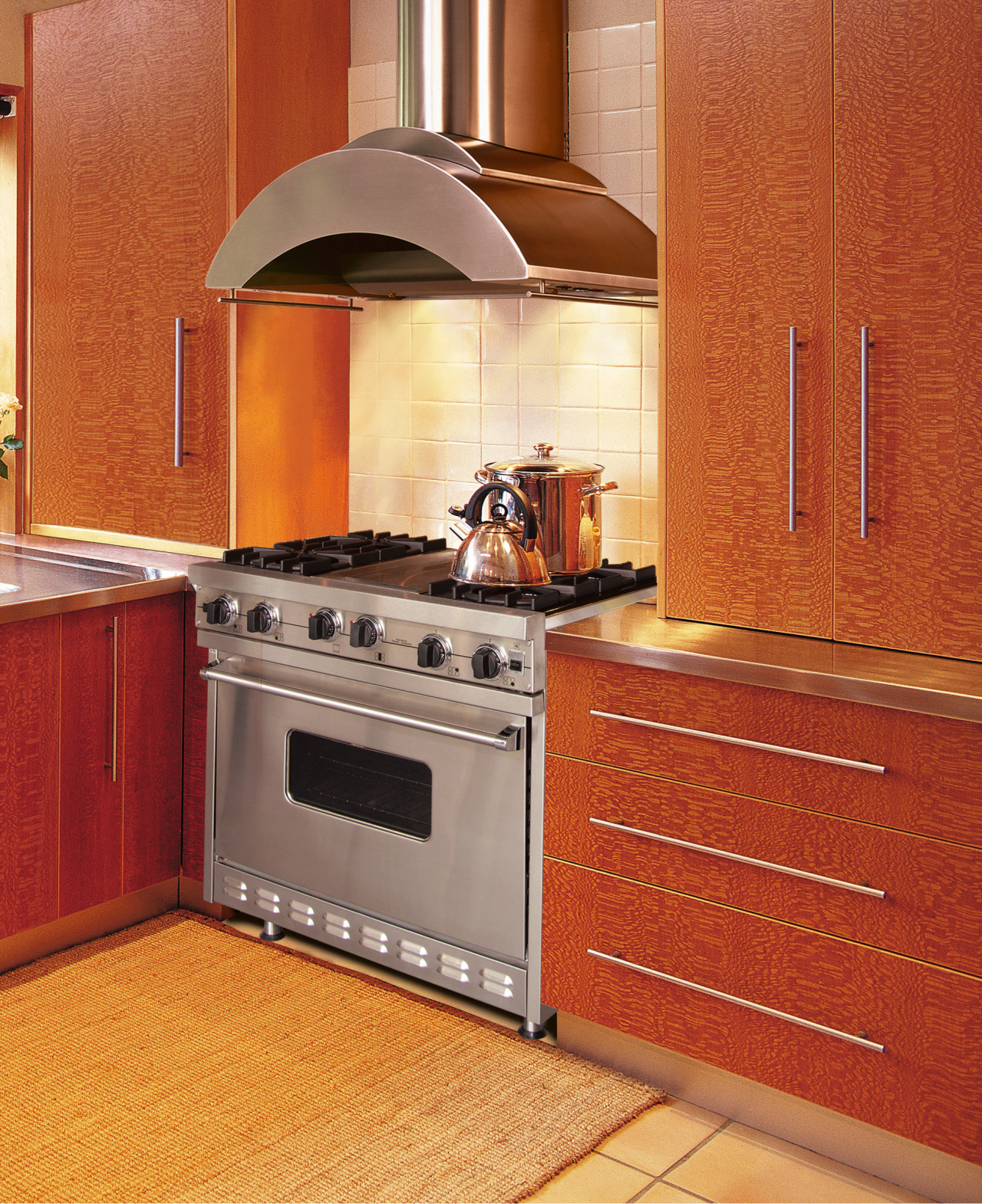 A view of a ventilation system from Vent-A-Hood. cabinetry, countertop, cuisine classique, floor, flooring, hardwood, hearth, home appliance, interior design, kitchen, kitchen appliance, kitchen stove, major appliance, orange, oven, room, tile, red, orange