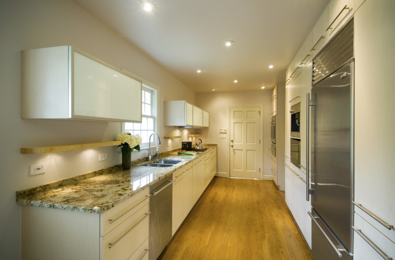 A view of this minimalist clean lined kitchen cabinetry, ceiling, countertop, cuisine classique, interior design, kitchen, real estate, room, brown, orange
