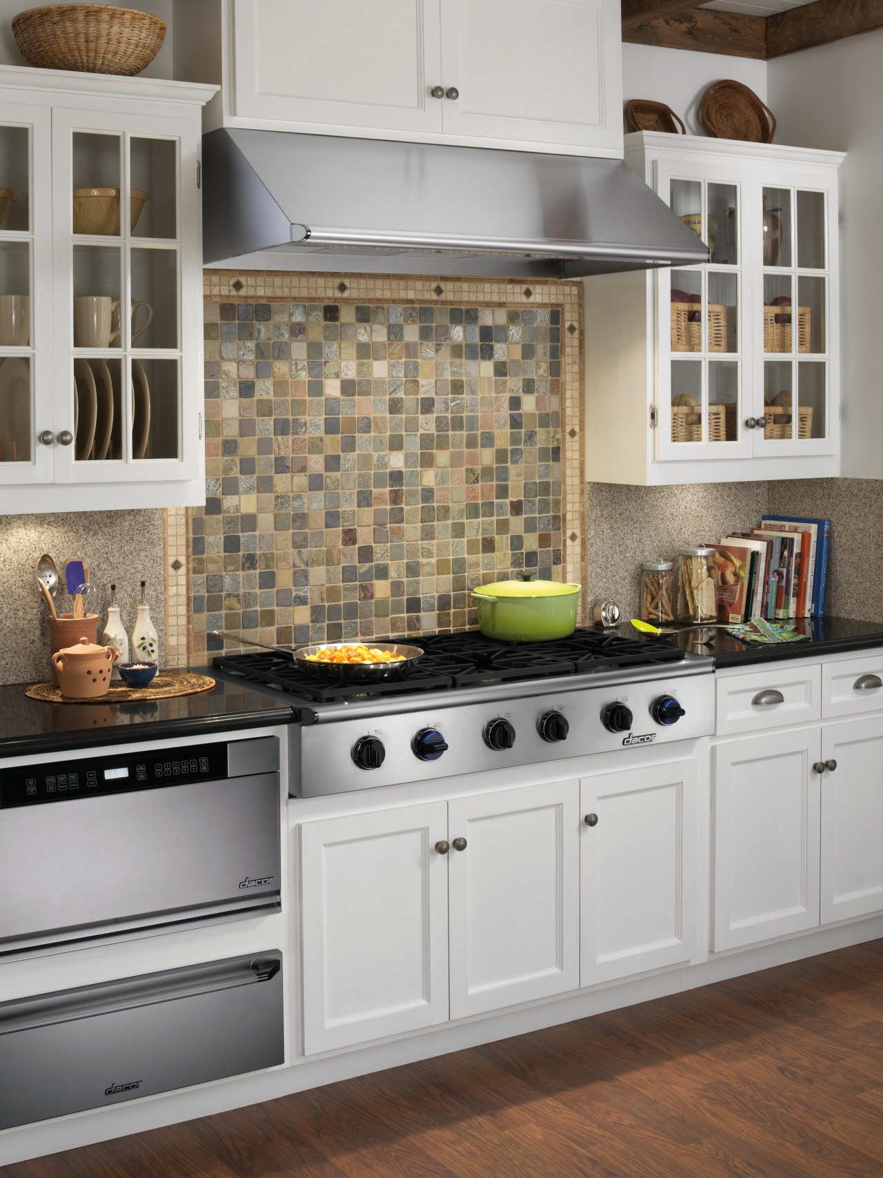 A view of this kitchen featuring the latest cabinetry, countertop, cuisine classique, floor, flooring, home appliance, interior design, kitchen, kitchen appliance, kitchen stove, room, tile, wood flooring, gray