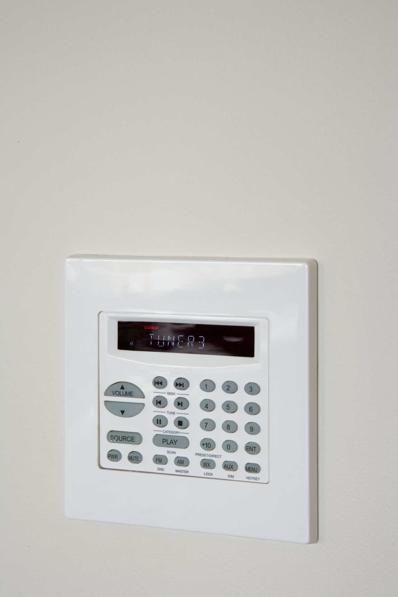 A Nuvo Multiroom Audio Keypad with LCD dispaly alarm device, product, product design, security alarm, gray