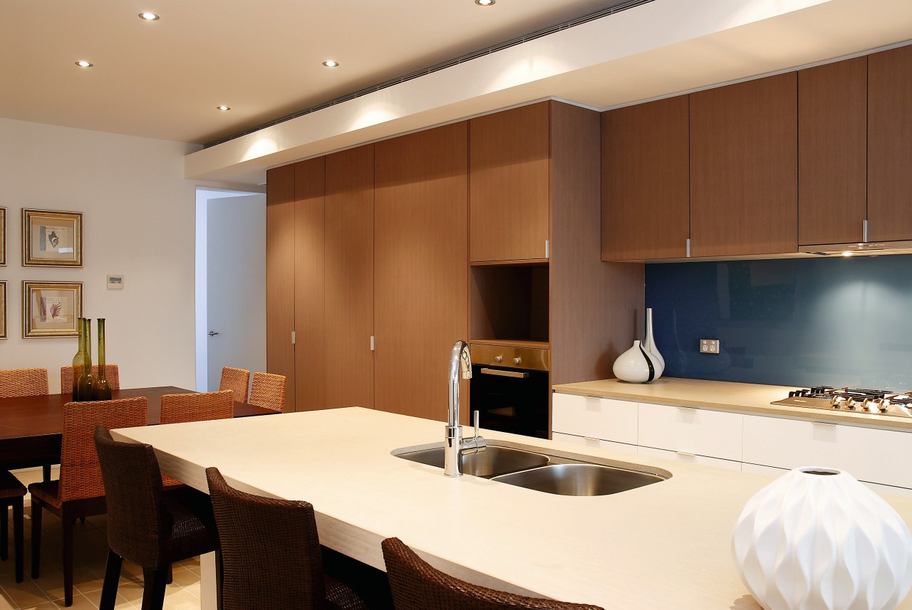 A view of the kitchen featuring white cabinetry, countertop, interior design, kitchen, real estate, room, brown, white