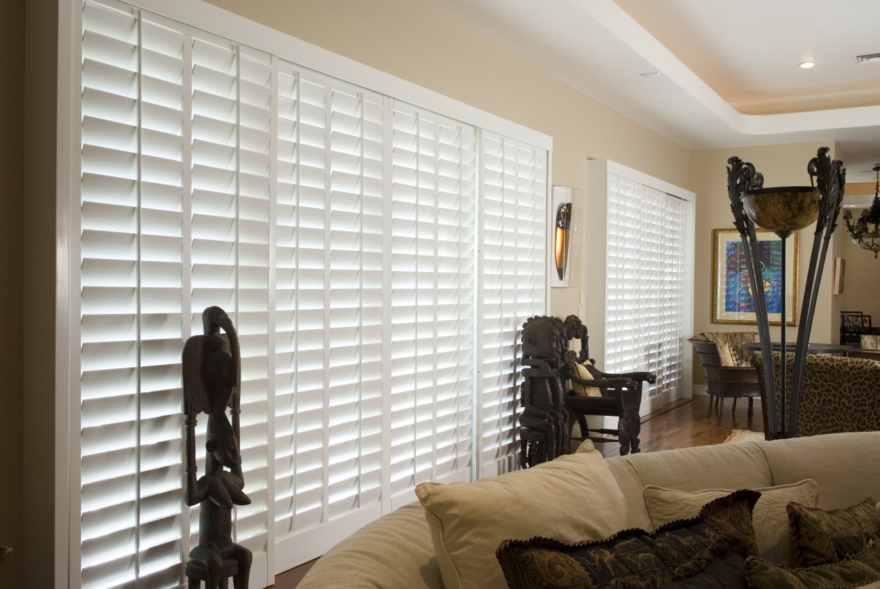 A view of the interior living areas featuring ceiling, curtain, home, interior design, living room, room, wall, window, window blind, window covering, window treatment, wood, gray