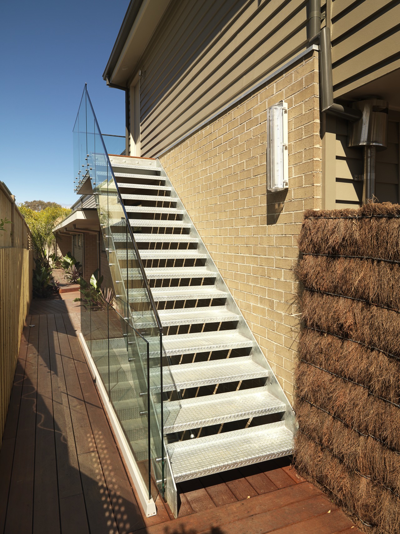 An exterior view of this house featuring Jame architecture, building, daylighting, facade, handrail, home, house, property, real estate, residential area, roof, siding, stairs, wall, window, wood, brown