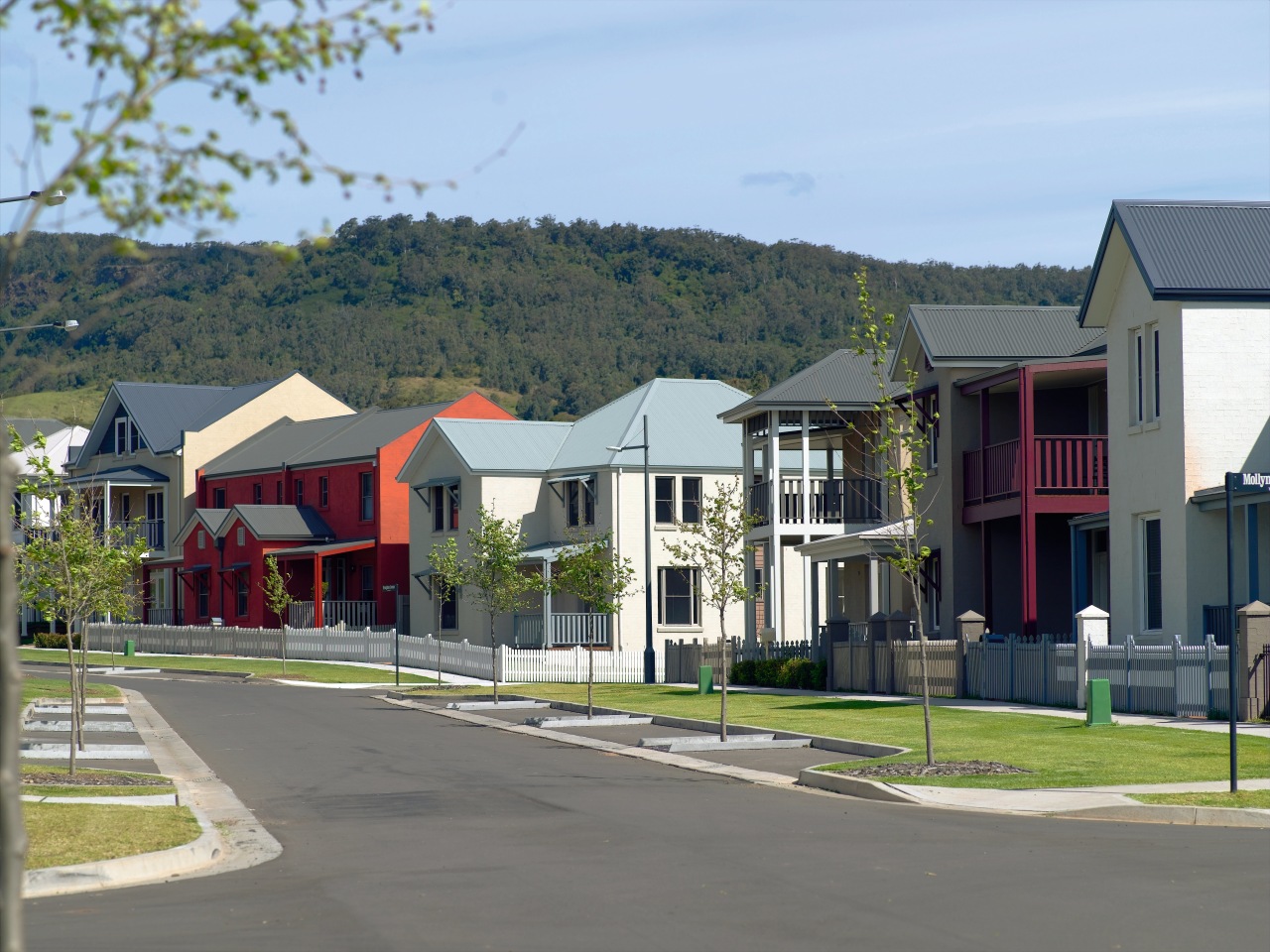 Tullimbar Village houses offer classic-look frontages, uncluttered by city, estate, home, house, mixed use, neighbourhood, property, real estate, residential area, road, suburb, town, tree, gray