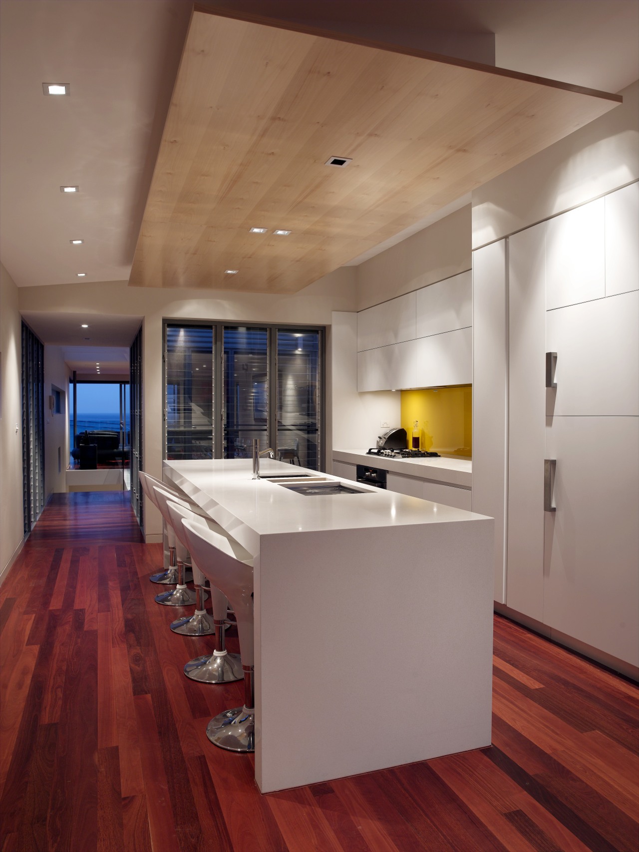 The glazed central courtyard divides the kitchenfrom the architecture, cabinetry, ceiling, countertop, floor, flooring, hardwood, house, interior design, kitchen, laminate flooring, loft, real estate, room, wall, wood, wood flooring, gray, red, brown