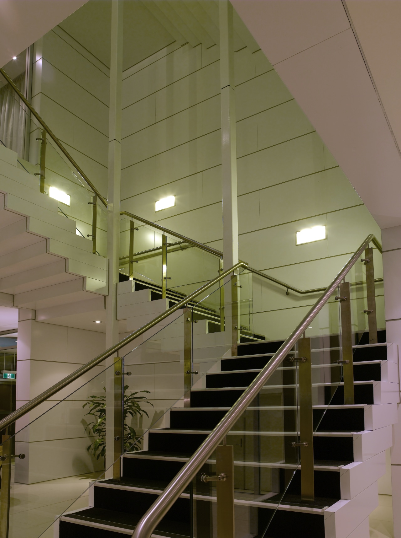 A view of this feature stair case where architecture, ceiling, daylighting, glass, handrail, interior design, stairs, structure, brown