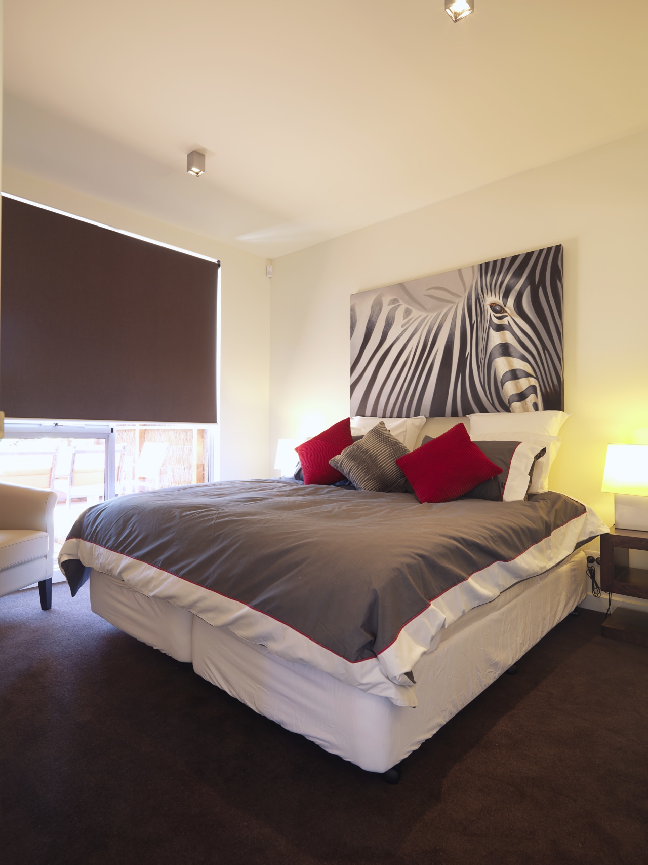 This plush-weave, Chaparral carpet was supplied and installed bed, bed frame, bed sheet, bedroom, ceiling, floor, furniture, home, interior design, mattress, real estate, room, suite, wall, wood, orange, black