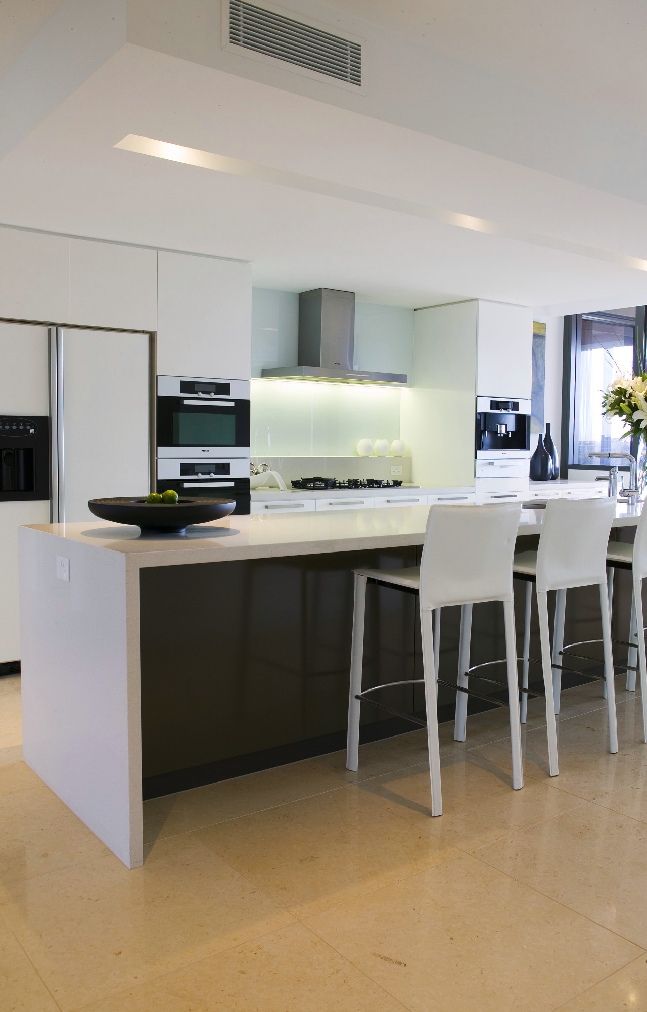 A view of the kitchen area featuring limestone floor, furniture, interior design, kitchen, real estate, table, gray