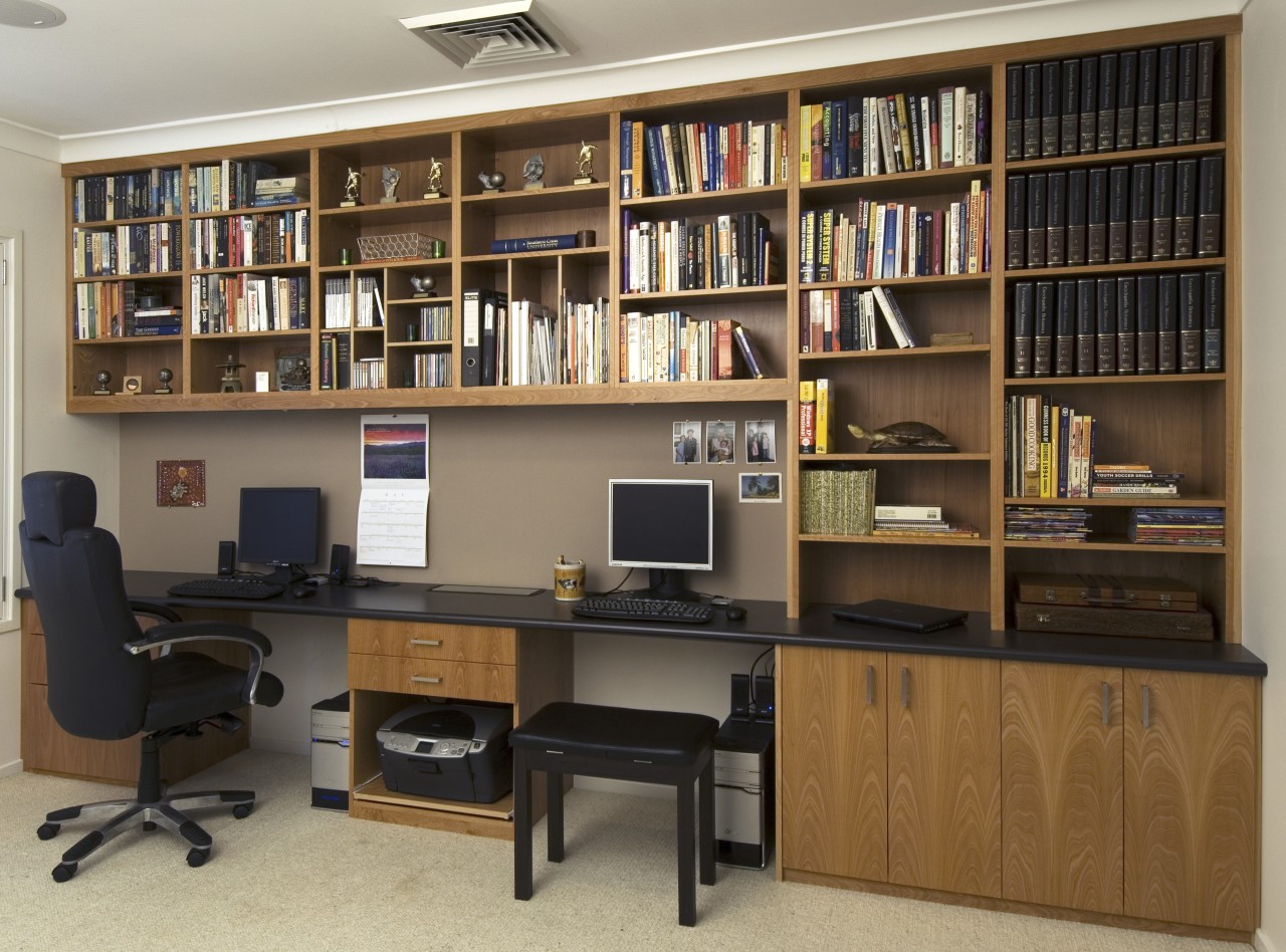 A view of a storage space by Creative bookcase, cabinetry, desk, furniture, institution, library, library science, office, public library, shelf, shelving, brown, black, gray