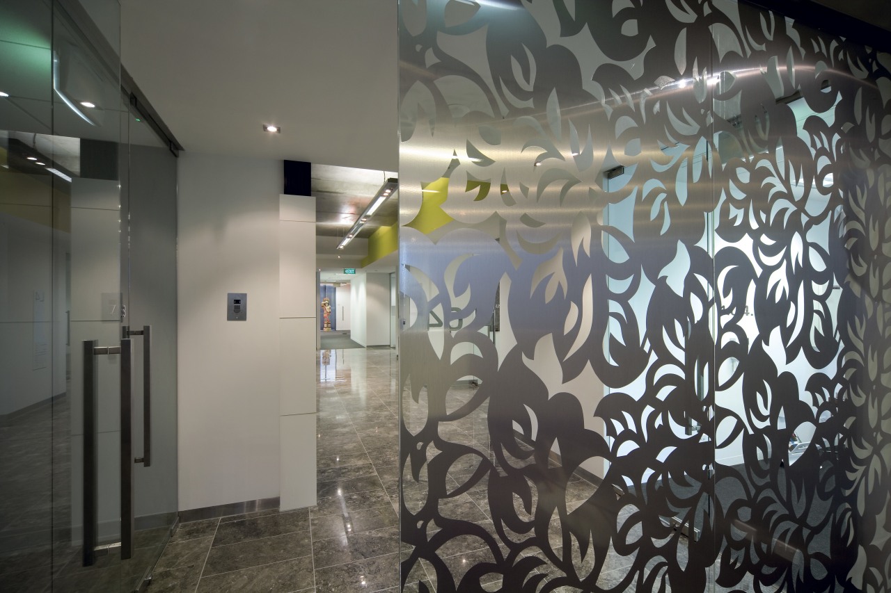 A glass screen with a delicate leaf pattern ceiling, glass, interior design, lobby, mural, wall, gray, black