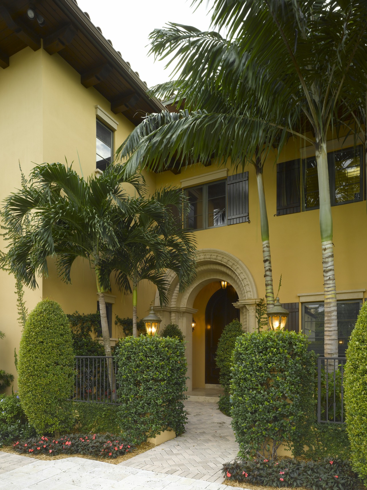 View of entrance, landscaping, paving. arecales, courtyard, home, house, palm tree, plant, property, real estate, tree, brown