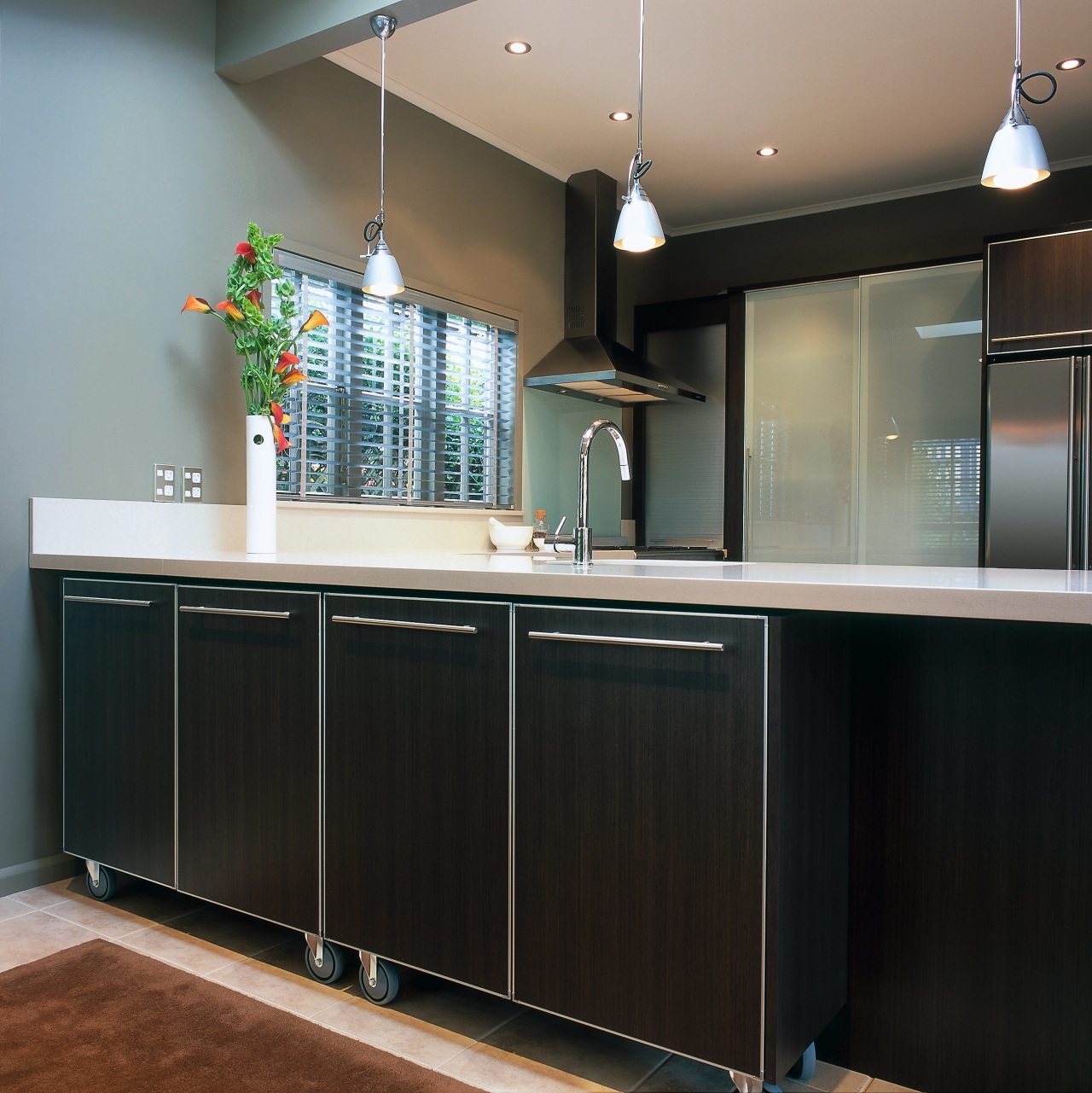 Minimalist horizontal detailing creates a contemporary feel, and cabinetry, countertop, cuisine classique, interior design, kitchen, room, black, gray