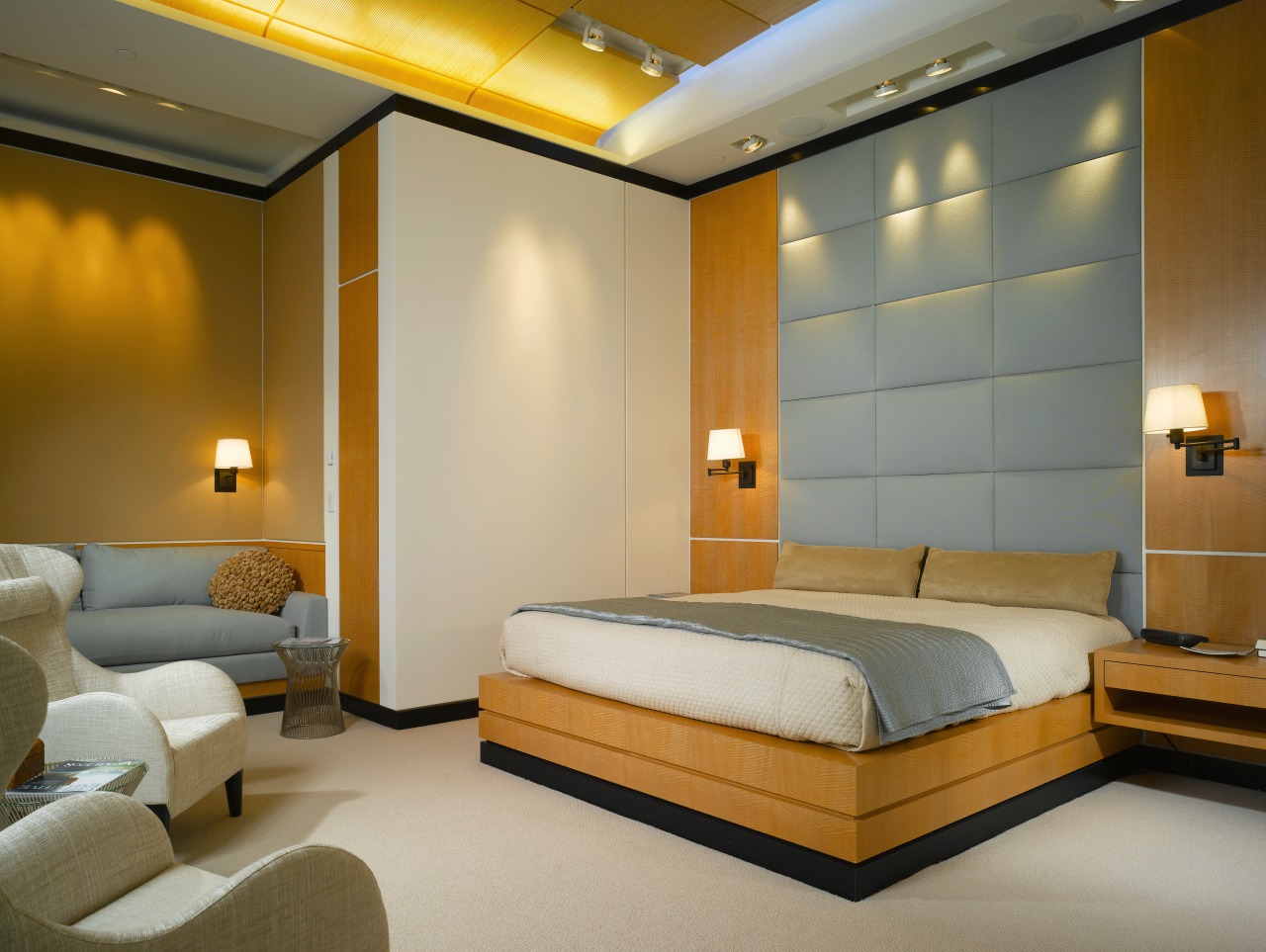 view of master bedroom featuring padded wall feature, bed frame, bedroom, ceiling, hotel, interior design, room, suite, wall, brown, orange, gray