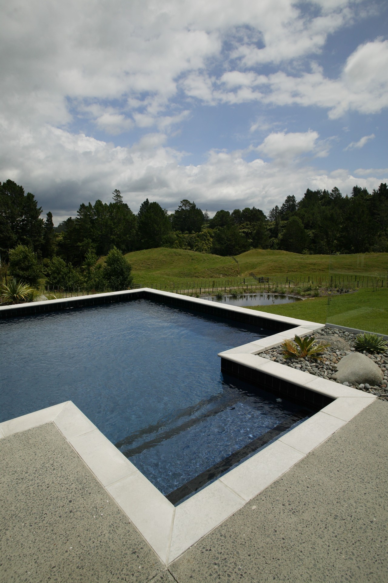 view of a pool by Pool Resources. cloud, estate, grass, landscape, leisure, real estate, reflecting pool, reflection, reservoir, sky, swimming pool, water, water feature, water resources, gray
