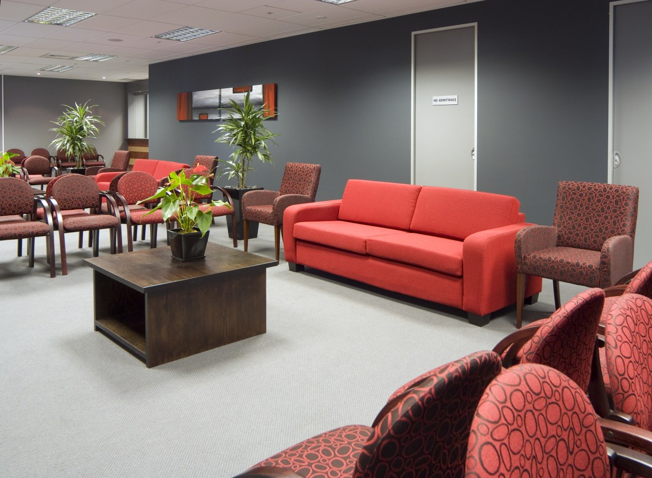 Vibrant red and gray furnishings  enliven the couch, furniture, interior design, living room, loveseat, room, table, waiting room, red, gray