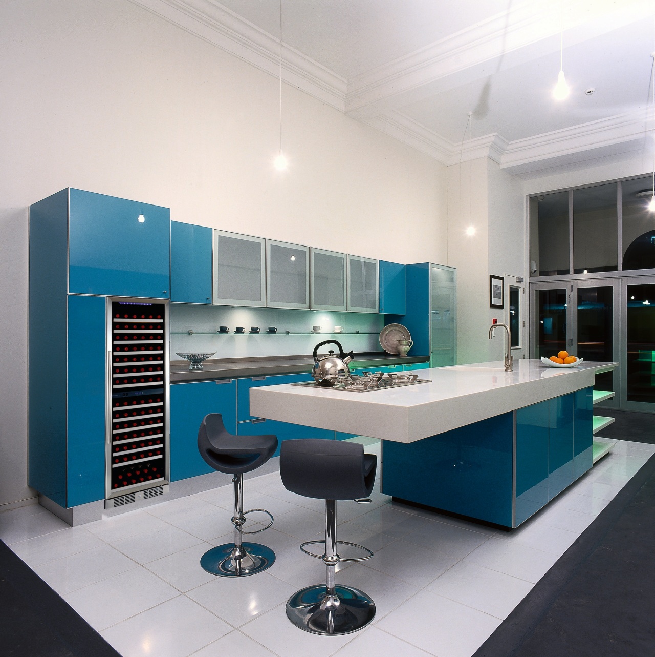 Open-plan winery kitchen with blue glass cupboards, long countertop, interior design, kitchen, product, product design, white, gray