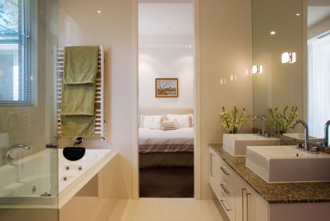 The main bathroom is shared by the two bathroom, estate, floor, home, interior design, room, sink, brown, gray