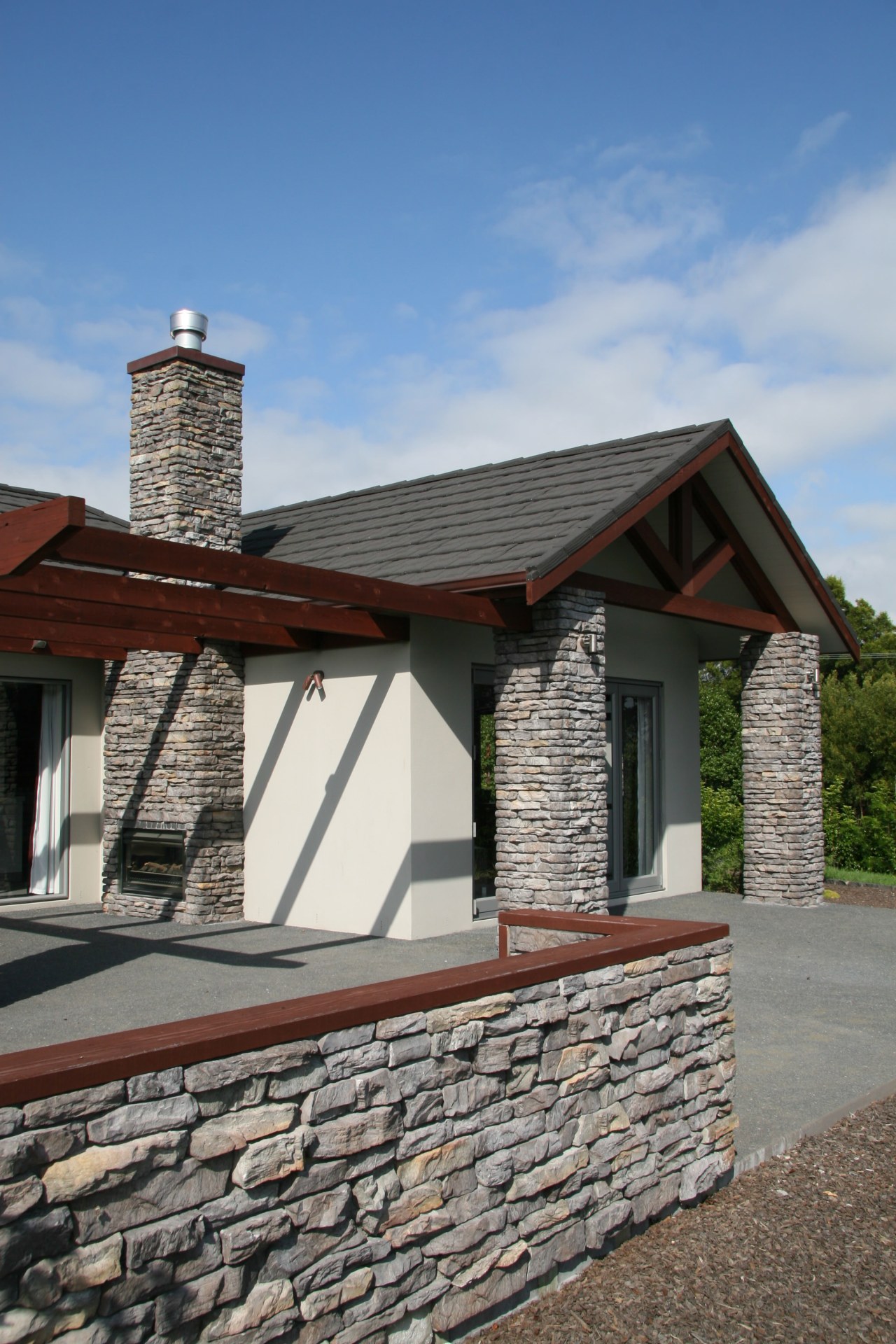 close up of house stutex stone chimney &amp; building, cottage, facade, farmhouse, home, house, property, real estate, roof, sky, wall, window, wood, gray