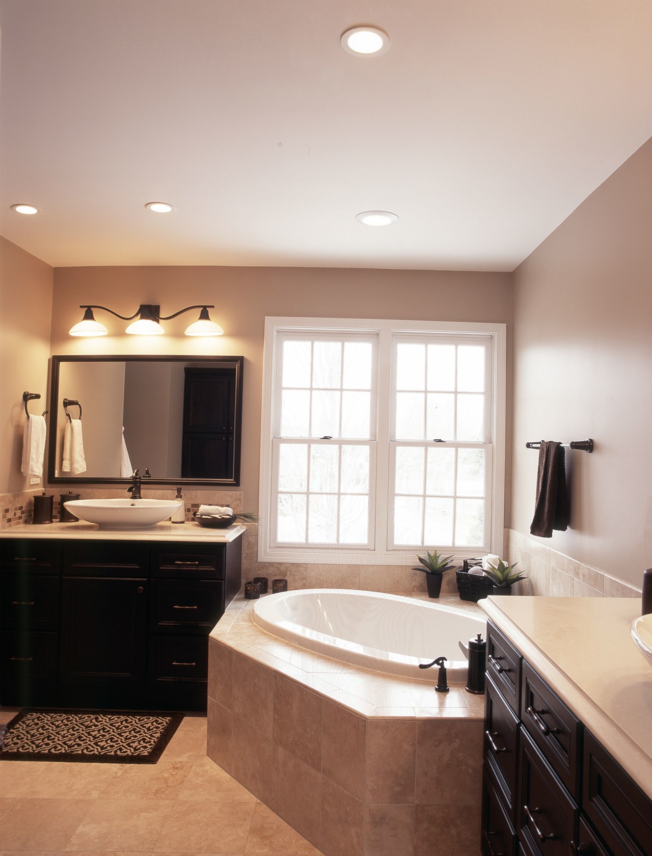 This bathroom had a plain color scheme with bathroom, cabinetry, ceiling, countertop, floor, flooring, home, interior design, kitchen, lighting, room, sink, wall, window, gray