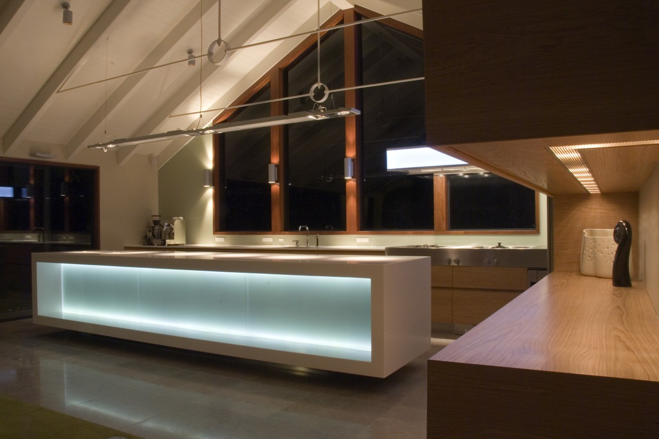 This new kitchen features a large Corian island architecture, interior design, lighting, brown