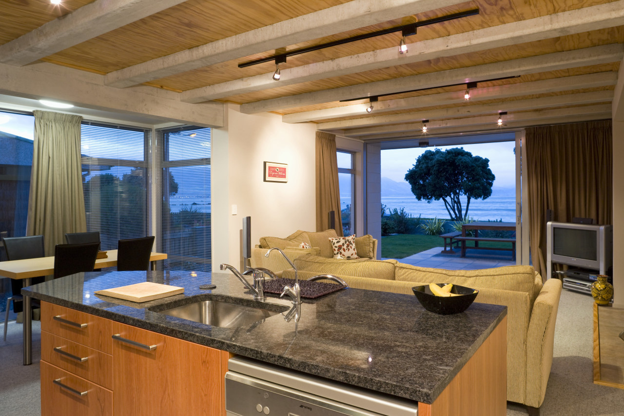 Glass sliding doors provide a connection between the countertop, estate, interior design, living room, real estate, room, window, wood, brown