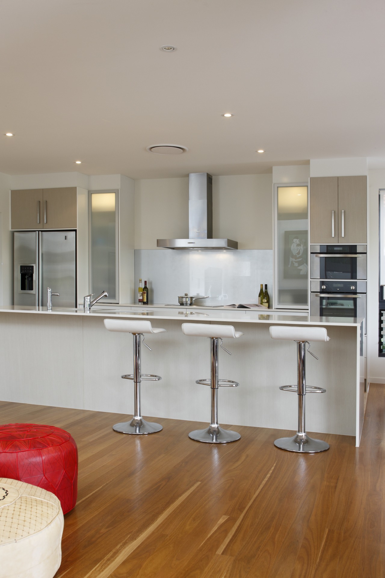 This kitchen combines a strong, simple aesthetic with cabinetry, countertop, cuisine classique, floor, flooring, hardwood, home, interior design, kitchen, laminate flooring, room, wall, wood, wood flooring, gray