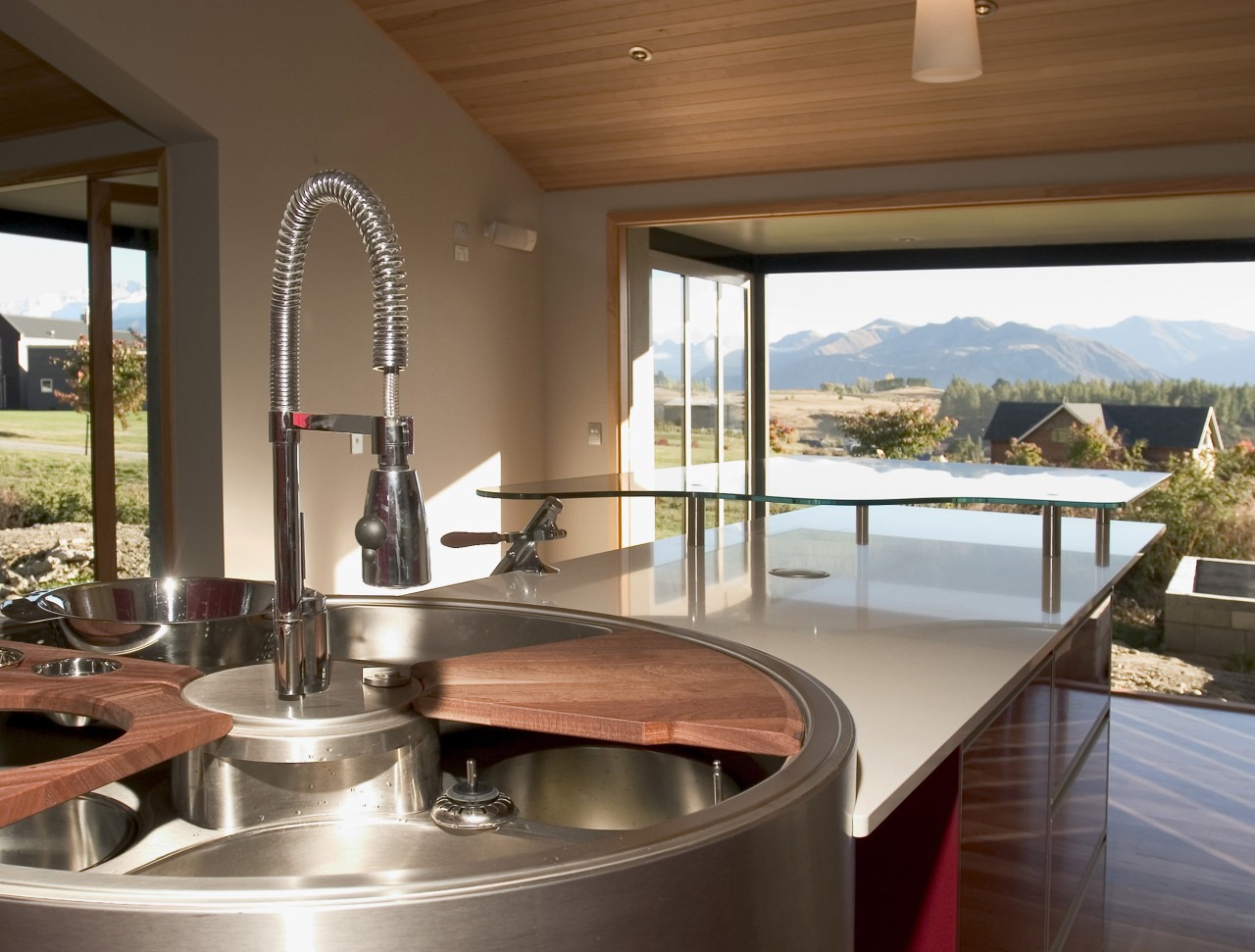 Kitchen designer Marianne Gailer has balanced Ferrari-red cabinetry countertop, estate, interior design, real estate, window, brown